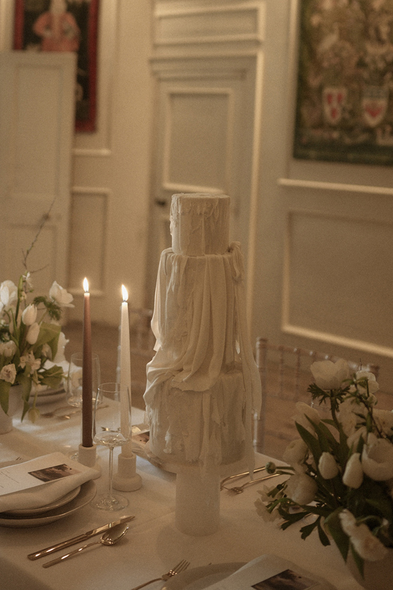 Sculpured, draped three-tier white cake by YiShi Cake